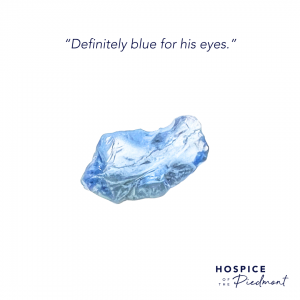 A piece of blue sea glass with the quote, “Definitely blue for his eyes.”