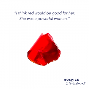 A piece of red sea glass with the quote, “I think red would be good for her. She was a powerful woman.”