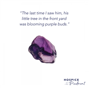 A piece of purple sea glass with the quote,“The last time I saw him, his little tree in the front yard was blooming purple buds.”