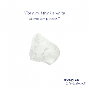 A piece of white sea glass with the quote, “For him, I think a white stone for peace.”