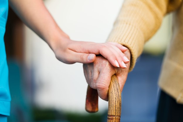 A close up image of people holding hands. Spiritual support in hospice.